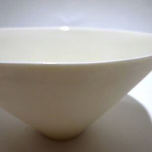 Close-up view from a slight angle above, a very fine white conical porcelain bowl, glazed on the inside with outside unglazed, available in Woburn Mosaic, contemporary art gallery