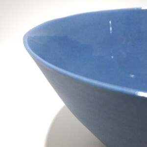 Viewed from an angle above, a close-up view of a very fine medium grey conical porcelain bowl, glazed on the inside with outside unglazed, available in Woburn Mosaic, contemporary art gallery