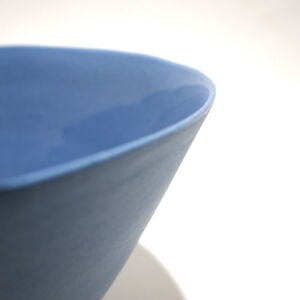 Viewed from slightly above, a close-up view of a very fine medium grey conical porcelain bowl, glazed on the inside with outside unglazed, available in Woburn Mosaic, contemporary art gallery