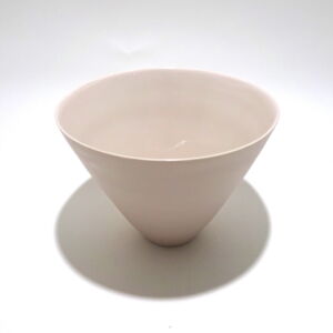 Viewed from a slight angle above, a very fine medium soft pink conical porcelain bowl, glazed on the inside with outside unglazed, available in Woburn Mosaic, contemporary art gallery