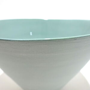 Viewed from slight angle above, a close-up view of a very fine medium, green conical earthenware bowl, glazed on the inside with outside unglazed, available in Woburn Mosaic, contemporary art gallery