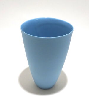 Viewed from a slight angle above, a very fine , tall turquoise porcelain tumbler, glazed on the inside with outside unglazed, available in Woburn Mosaic, contemporary art gallery