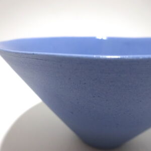 Viewed from a slight angle above, a close-up of a very fine , small, lavender conical porcelain bowl, glazed on the inside with outside unglazed, available in Woburn Mosaic, contemporary art gallery